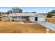Single-story home, attached garage, and mature landscaping at 10476 Se 178Th St, Summerfield, FL 34491