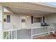 Front porch with white railing and two chairs at 10476 Se 178Th St, Summerfield, FL 34491
