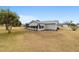 Rear view of house with screened porch at 10476 Se 178Th St, Summerfield, FL 34491