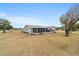 Rear view of house with screened porch and yard at 10476 Se 178Th St, Summerfield, FL 34491