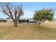 Rear view of house with screened porch and yard at 10476 Se 178Th St, Summerfield, FL 34491