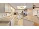 Well-lit kitchen with white cabinetry and a skylight at 10476 Se 178Th St, Summerfield, FL 34491