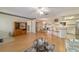 Open concept living room, kitchen, and dining area with light wood floors at 10476 Se 178Th St, Summerfield, FL 34491