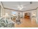 Living room with sofa, wood floors and view into adjacent bedroom at 10476 Se 178Th St, Summerfield, FL 34491