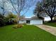 Light blue house with a gray roof, landscaped lawn, and a driveway at 11307 Mandarin Dr, Clermont, FL 34711