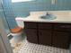 Bathroom with light blue tile and wood vanity at 1220 Beulah Rd, Winter Garden, FL 34787