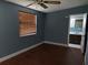 Blue bedroom with hardwood floor and access to bathroom at 1220 Beulah Rd, Winter Garden, FL 34787