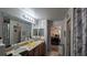 Bathroom with double vanity and view of bedroom at 12288 Ne 48Th Loop, Oxford, FL 34484