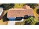 Aerial view of single-story house, showing roof, driveway, and landscaping at 13709 Se 89Th Ave, Summerfield, FL 34491