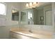 Bathroom features a vanity with sink and large mirror at 13709 Se 89Th Ave, Summerfield, FL 34491