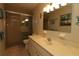 Bathroom with shower, toilet and a vanity with sink at 13709 Se 89Th Ave, Summerfield, FL 34491