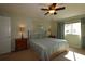 Bright bedroom with large window and ceiling fan at 13709 Se 89Th Ave, Summerfield, FL 34491
