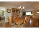 Spacious dining room with hardwood floors, a large table, and access to other rooms at 13709 Se 89Th Ave, Summerfield, FL 34491