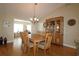 Dining room with hardwood floors, a wooden table, and a china cabinet at 13709 Se 89Th Ave, Summerfield, FL 34491