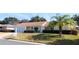 Single-story house with covered porch and palm tree at 13709 Se 89Th Ave, Summerfield, FL 34491