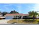 Single story house with a two-car garage and nicely landscaped yard at 13709 Se 89Th Ave, Summerfield, FL 34491