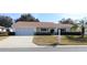 Single-story house with screened garage and landscaped yard at 13709 Se 89Th Ave, Summerfield, FL 34491