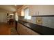 Eat-in kitchen with hardwood floors and modern cabinetry at 13709 Se 89Th Ave, Summerfield, FL 34491