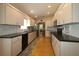 Modern kitchen with stainless steel appliances and dark countertops at 13709 Se 89Th Ave, Summerfield, FL 34491