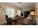 Cozy living room featuring a large TV and comfortable seating at 13709 Se 89Th Ave, Summerfield, FL 34491