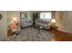 Living room with hardwood floors, neutral decor, and comfortable seating arrangement at 13709 Se 89Th Ave, Summerfield, FL 34491