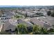 Aerial view highlighting a home's backyard, solar panels, and surrounding houses in a community at 1418 Mccoll Ct, The Villages, FL 32162