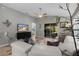 Bright living room with comfy seating and sliding glass doors leading to a screened patio at 1418 Mccoll Ct, The Villages, FL 32162