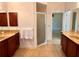 Large bathroom with double vanity and shower at 1515 Gadsden Pl, The Villages, FL 32162