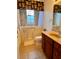 Accessible bathroom featuring a walk-in tub with shower and single sink vanity at 1515 Gadsden Pl, The Villages, FL 32162