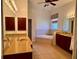 Primary bathroom featuring dual sink vanity, walk-in shower, jacuzzi tub, and tile flooring at 1515 Gadsden Pl, The Villages, FL 32162