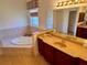 Bathroom with double vanity, garden tub, and separate shower at 1515 Gadsden Pl, The Villages, FL 32162