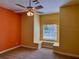 Bedroom with built-in window seat and ceiling fan at 1515 Gadsden Pl, The Villages, FL 32162