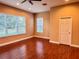 Bedroom with hardwood floors, large windows, and a closet at 1515 Gadsden Pl, The Villages, FL 32162