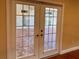 White French doors opening to a brick paved patio at 1515 Gadsden Pl, The Villages, FL 32162