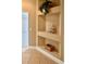 Hallway with built-in shelves and tile flooring at 1515 Gadsden Pl, The Villages, FL 32162