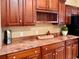 Kitchen features granite countertops and rich wood cabinets at 1515 Gadsden Pl, The Villages, FL 32162
