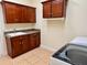 Laundry room with sink, cabinets, and space for washer/dryer at 1515 Gadsden Pl, The Villages, FL 32162