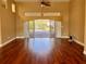 Spacious living room with hardwood floors and sliding glass doors at 1515 Gadsden Pl, The Villages, FL 32162
