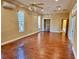 Large main bedroom with hardwood floors, high ceilings and two ceiling fans at 1515 Gadsden Pl, The Villages, FL 32162