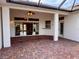 Spacious brick patio with covered lanai and ceiling fan at 1515 Gadsden Pl, The Villages, FL 32162