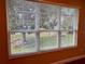 Window with white blinds overlooking a grassy backyard at 1515 Gadsden Pl, The Villages, FL 32162