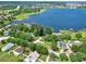 Aerial view of waterfront property with lake access and lush landscaping at 16011 Lanesboro Ct, Clermont, FL 34711