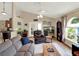 Living room with a sectional sofa, French doors, and a fish tank at 16011 Lanesboro Ct, Clermont, FL 34711