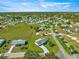 Aerial view of a well-maintained home with a green lawn in a friendly residential neighborhood at 17664 Se 105Th Terrace, Summerfield, FL 34491