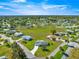 Aerial view featuring a residential community with well-maintained lawns and beautiful landscaping at 17664 Se 105Th Terrace, Summerfield, FL 34491
