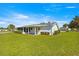Spacious backyard showcasing a screen porch, lush lawn and a tidy, well-maintained property at 17664 Se 105Th Terrace, Summerfield, FL 34491