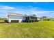 Exterior side view of house with lawn and covered sun room at 17664 Se 105Th Terrace, Summerfield, FL 34491