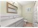 Bright bathroom featuring a vanity with a sink, toilet, shower with curtain and tile flooring at 17664 Se 105Th Terrace, Summerfield, FL 34491