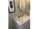 Clean bathroom with marble vanity and a large mirror at 17664 Se 105Th Terrace, Summerfield, FL 34491