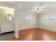 Spacious bedroom with wood floors, ceiling fan, and ensuite bathroom at 17664 Se 105Th Terrace, Summerfield, FL 34491